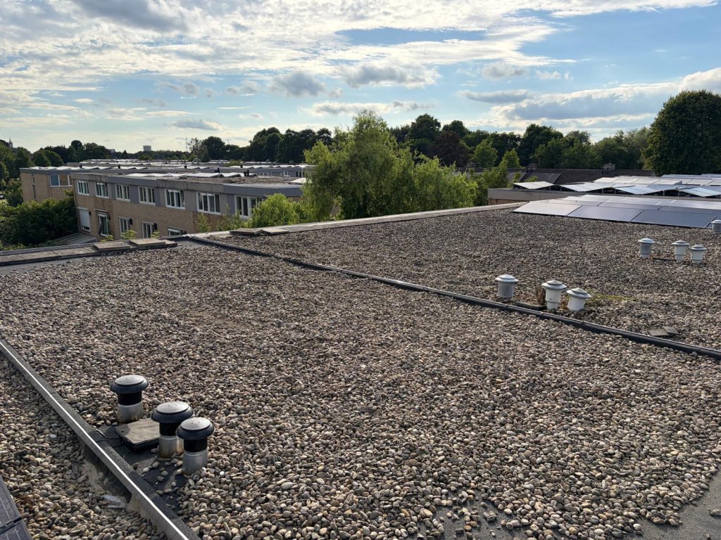 Nieuw plat dak met teruggelegd grind na de renovatie